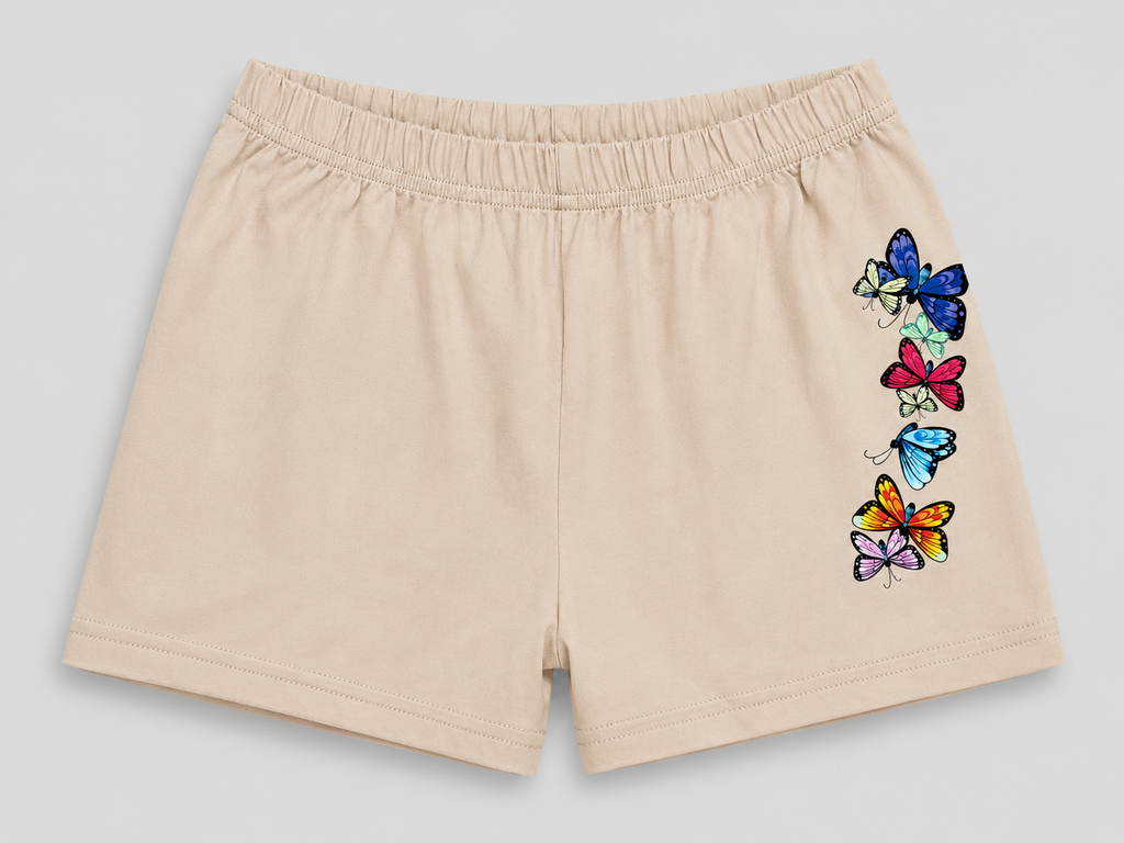 Beige athletic shorts with an elastic waistband and a vertical graphic of colorful embroidered butterflies on the left leg, shown against a neutral gray background.