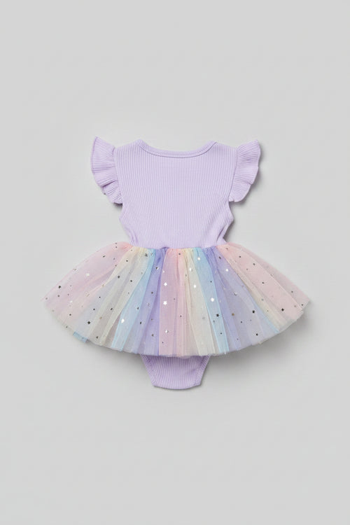 Back side of a baby girl's off-the-shoulder bodysuit with a pastel rainbow tulle tutu skirt and star embellishments.