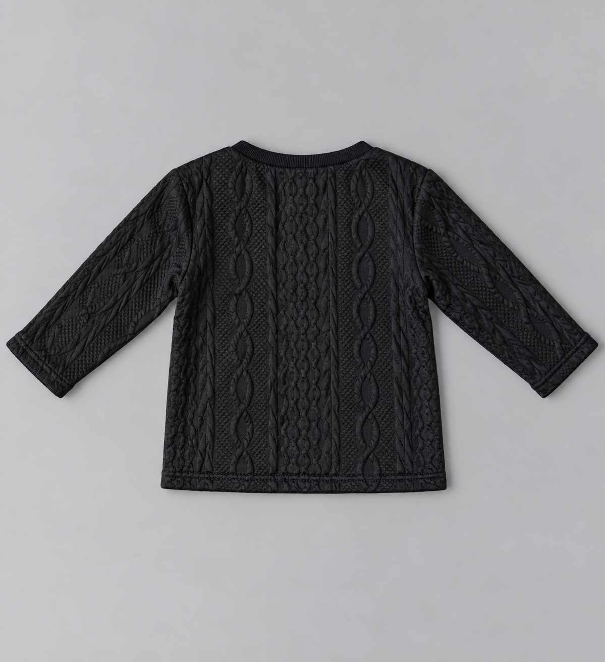 Back view of black kids long-sleeve cable-knit textured top with allover raised cable pattern