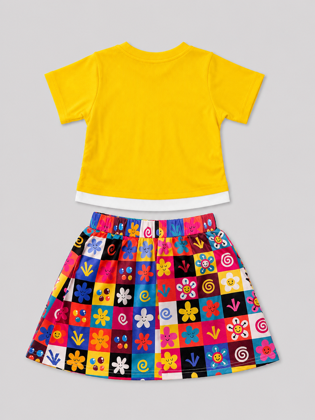 Girls yellow ribbed top with white layered hem and multicolor printed checkerboard skirt two-piece outfit, back view, size 4Y.