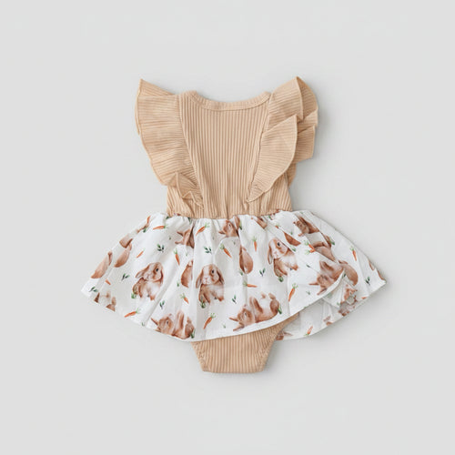 Adorable Baby Girls Bunny Print Dress Romper featuring flutter sleeves, a soft ribbed bodice, bunny print skirt, and built-in romper. Perfect for Easter, spring, birthdays, and everyday boutique style.