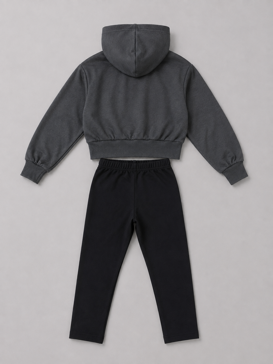 A two-piece clothing set featuring a dark gray cropped hoodie with long sleeves and black drawstring pants.