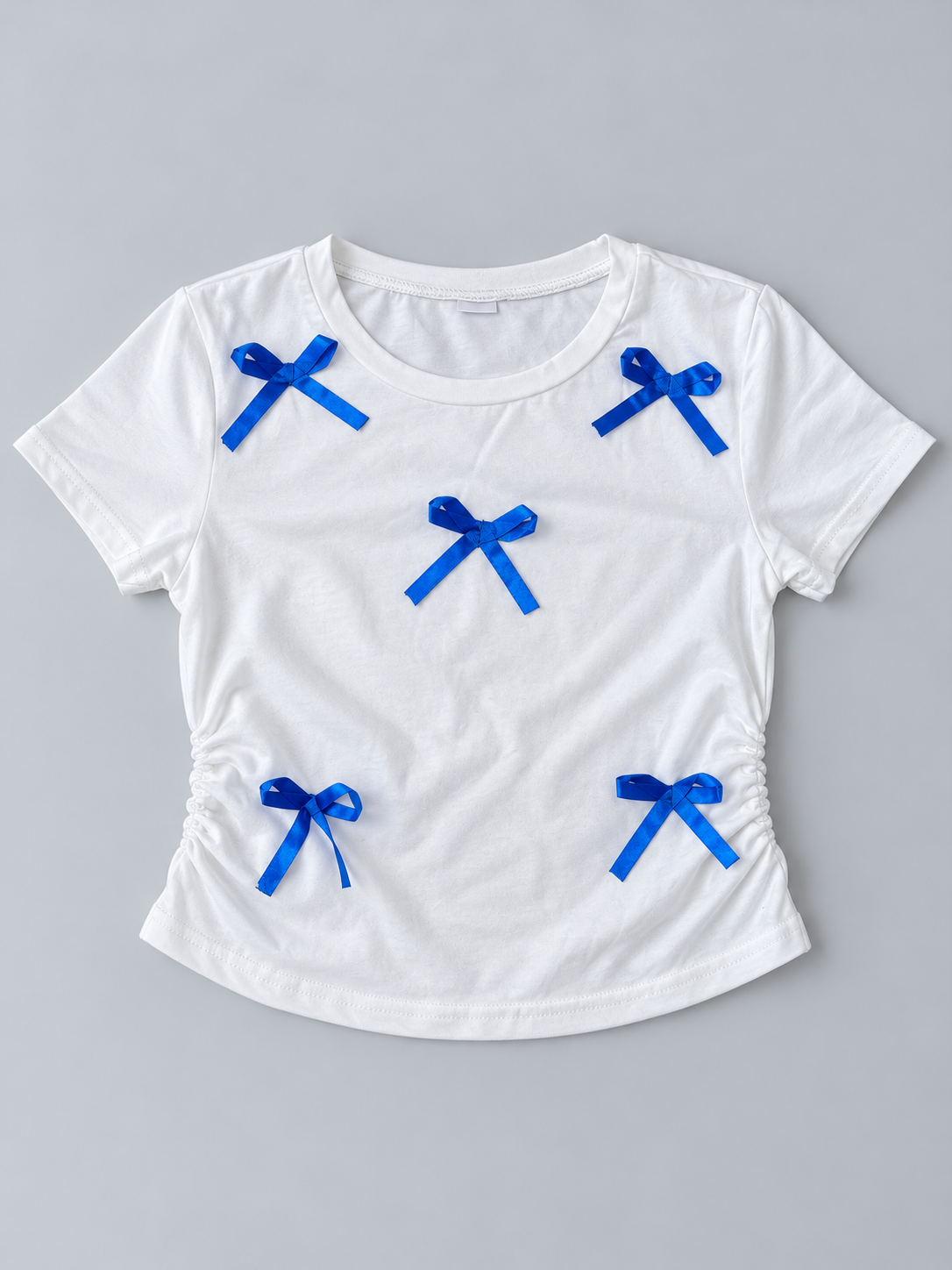 Girls white short-sleeve ruched T-shirt with royal blue satin bow accents