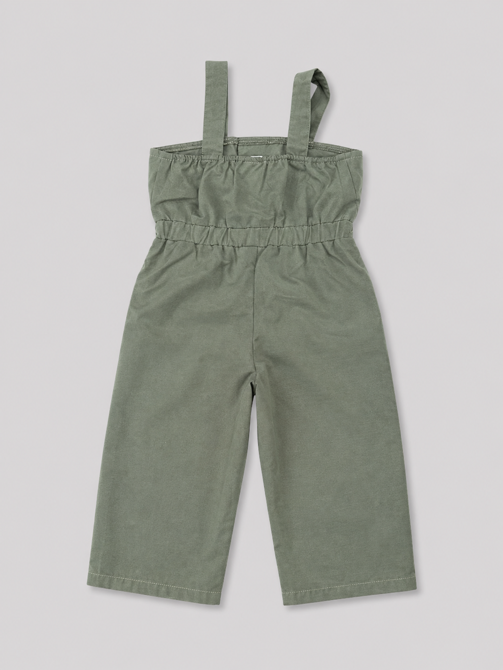 Olive green utility-style jumpsuit for girls featuring a comfortable elasticized waist, wide-leg pants, shoulder straps, and button-flap pocket details. Perfect for casual everyday wear, vacations, and summer outfits.