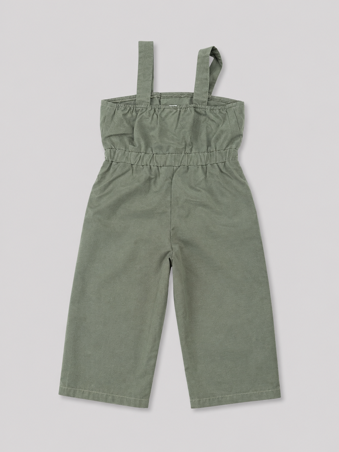 Olive green utility-style jumpsuit for girls featuring a comfortable elasticized waist, wide-leg pants, shoulder straps, and button-flap pocket details. Perfect for casual everyday wear, vacations, and summer outfits.