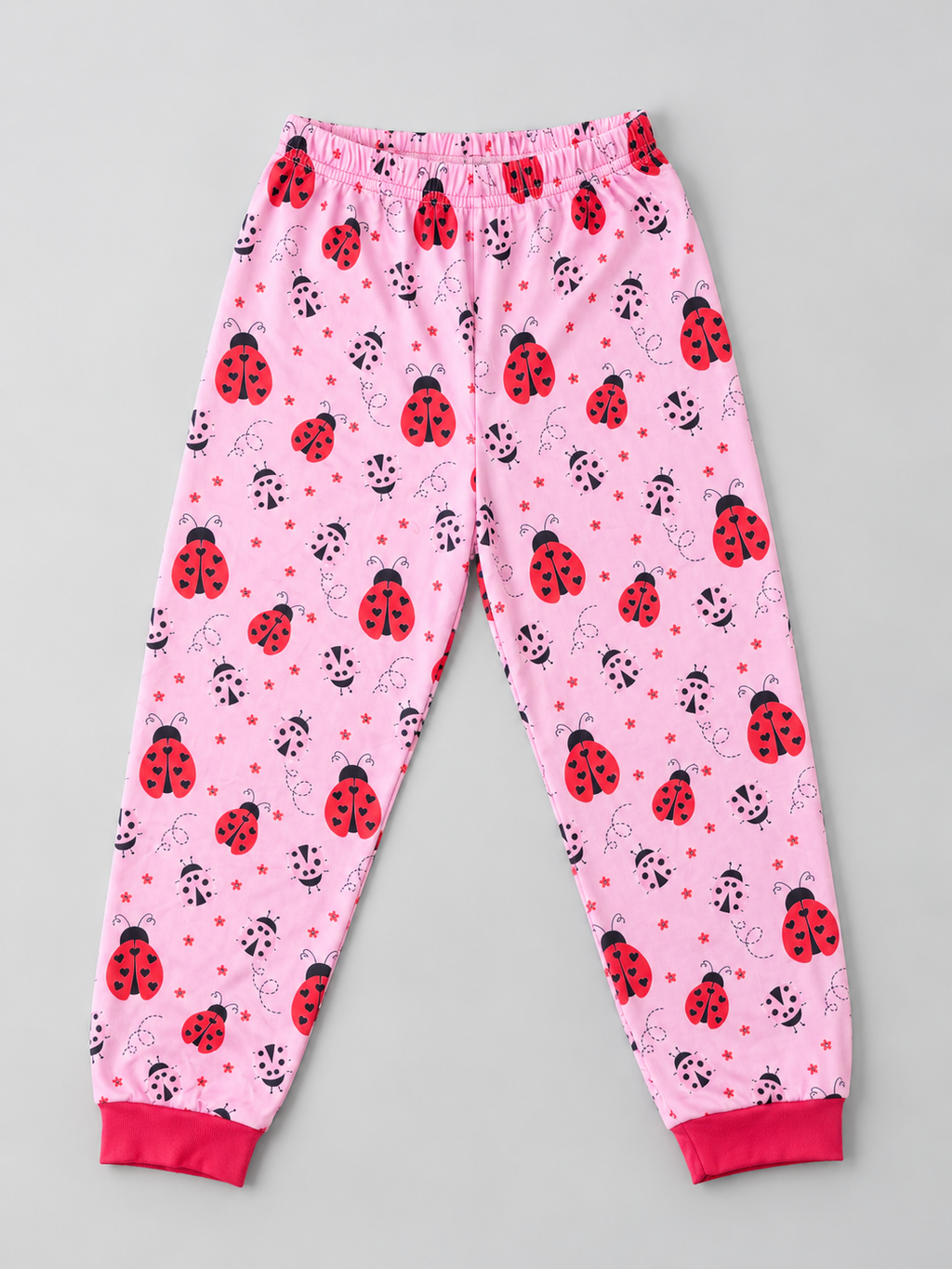 Girls pink ladybug print pajama pants with red ankle cuffs, front view