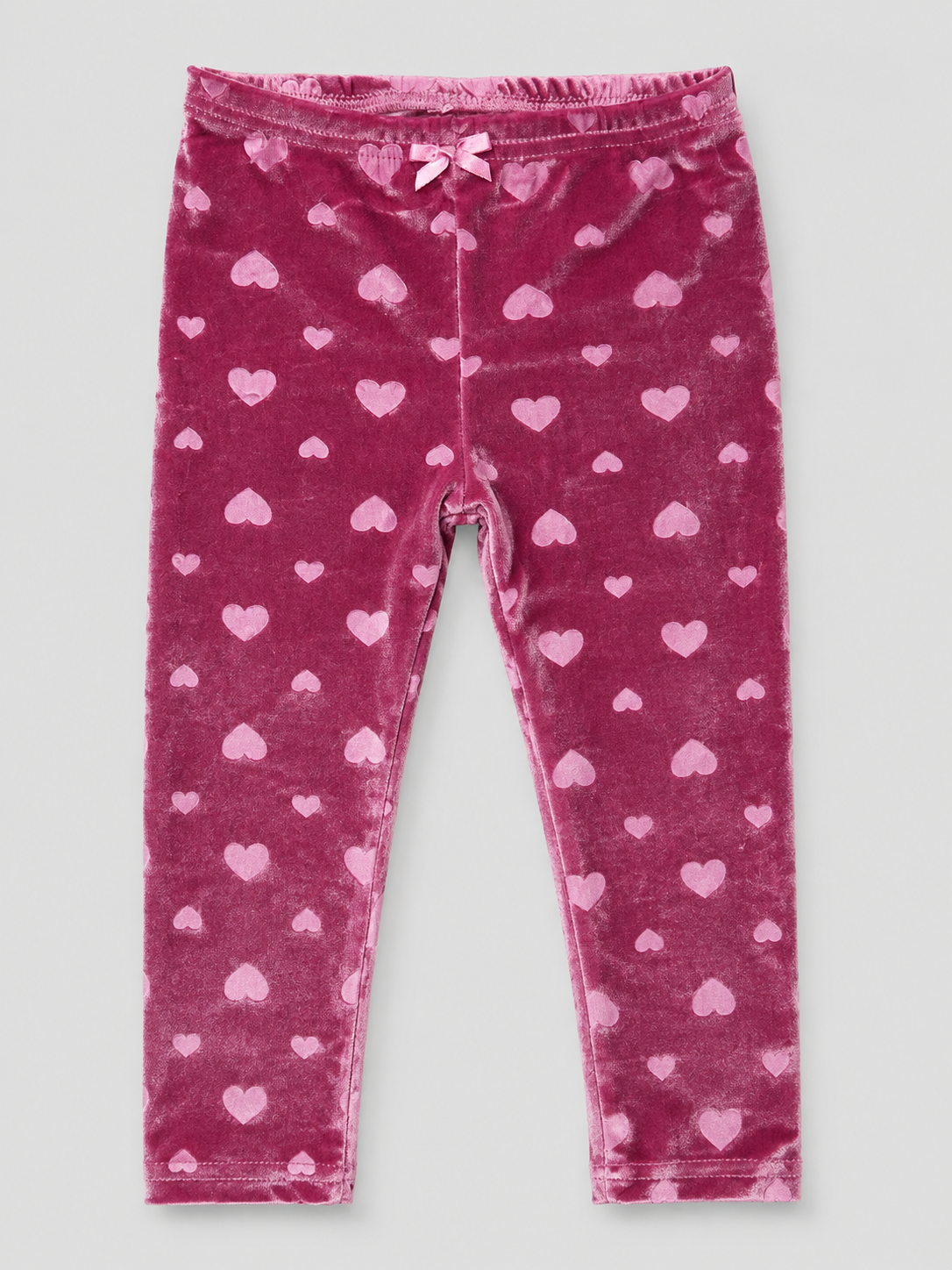 Girls' blush pink velvet leggings featuring an embossed heart design, stretchy fit, and soft plush fabric. Perfect for Valentine's Day, holidays, and cozy fall and winter outfits.