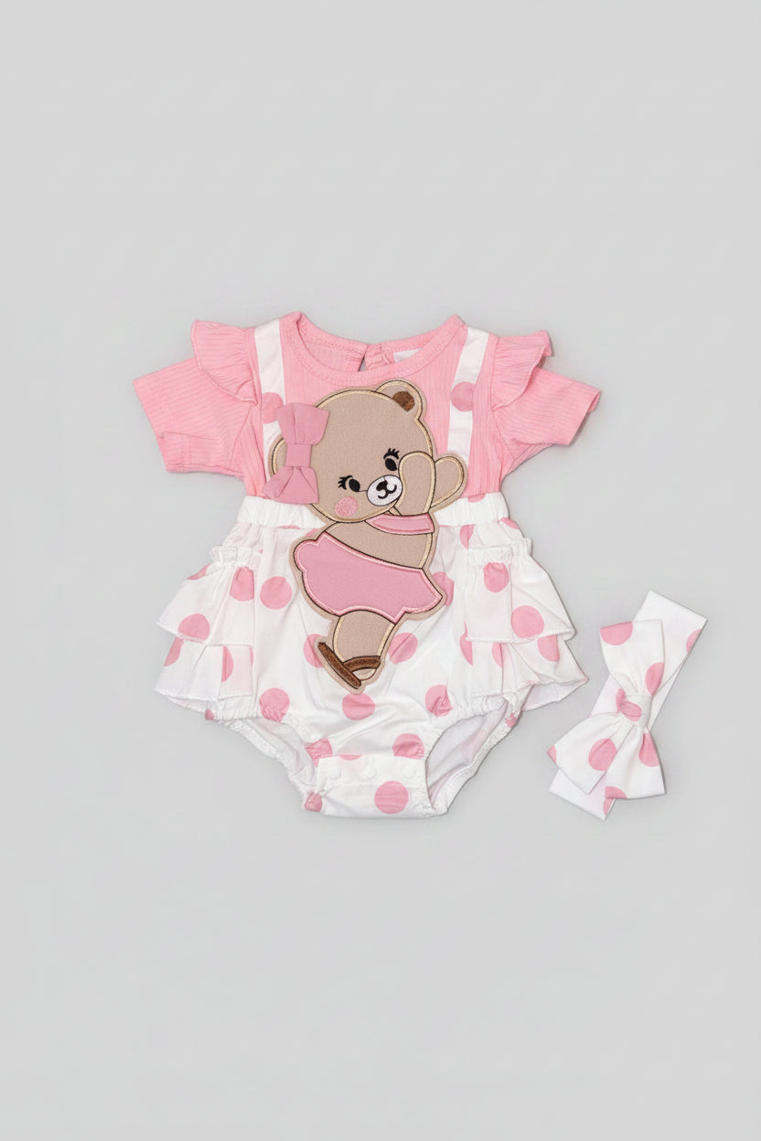 Baby girl pink polka dot bubble romper featuring an embroidered teddy bear applique, flutter sleeves, layered ruffles, and a matching headband. A boutique outfit perfect for birthdays, family photos, baby showers, and everyday wear.