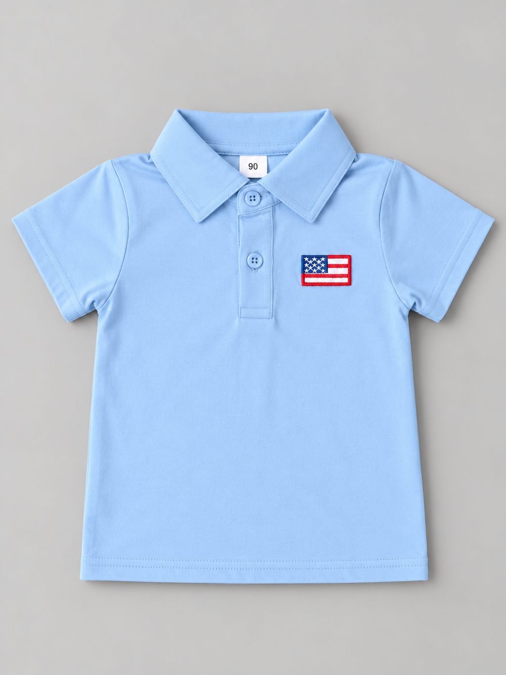 Boys light blue short sleeve polo shirt with embroidered American flag chest patch