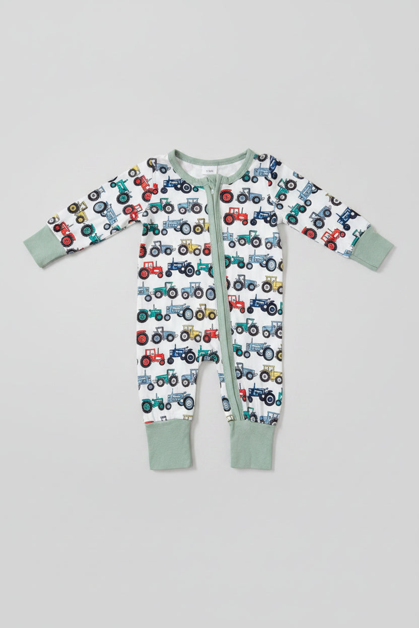 Soft baby tractor print zip-up sleeper featuring a full-length zipper, long sleeves, and comfortable ribbed cuffs. Perfect for sleeping, playing, and everyday adventures.