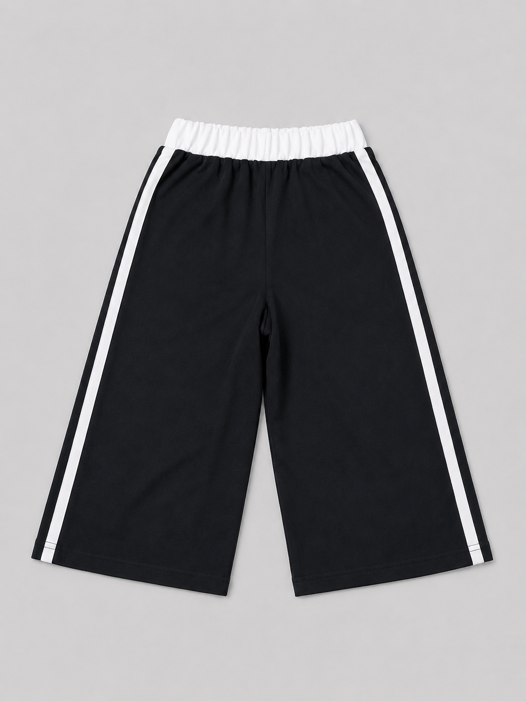 Black athletic shorts featuring white side stripes, an elastic waistband, and a “Brooklyn New York” graphic. A versatile choice for school, sports, playtime, and everyday casual wear.