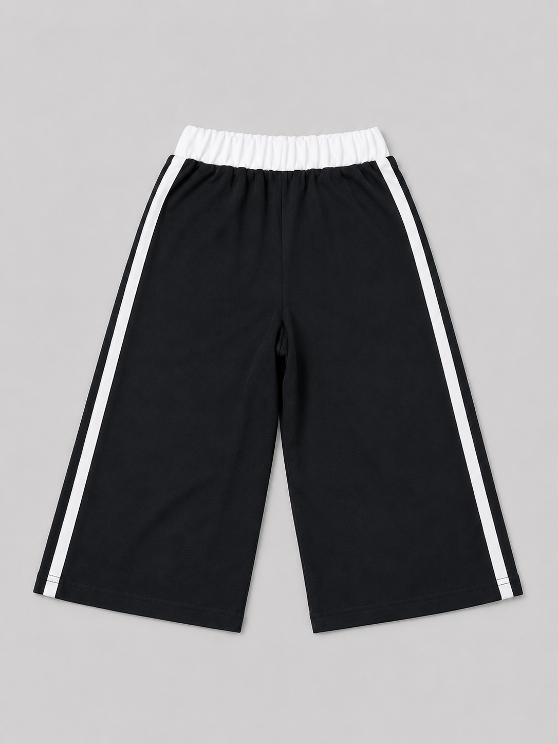 Black athletic shorts featuring white side stripes, an elastic waistband, and a “Brooklyn New York” graphic. A versatile choice for school, sports, playtime, and everyday casual wear.