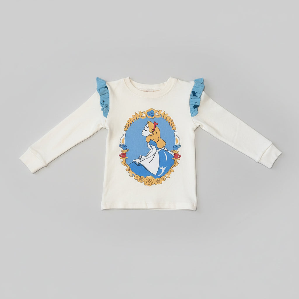 Ivory toddler long-sleeve top featuring an Alice in Wonderland character graphic with blue ruffle shoulder accents.