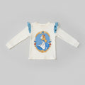 Ivory toddler long-sleeve top featuring an Alice in Wonderland character graphic with blue ruffle shoulder accents.