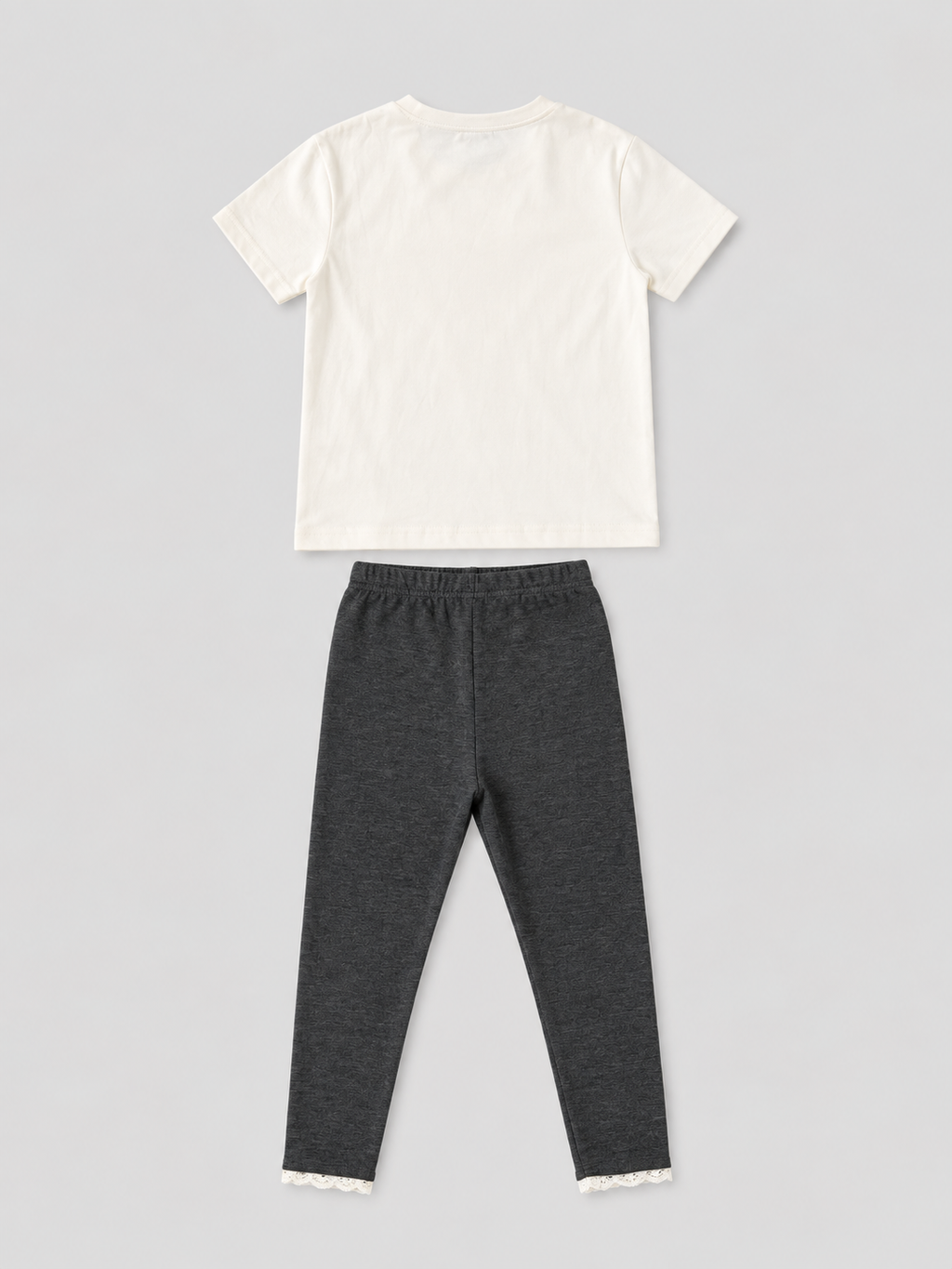 Girls ivory short-sleeve T-shirt and charcoal gray lace-trim leggings two-piece outfit, back view, size 4Y.