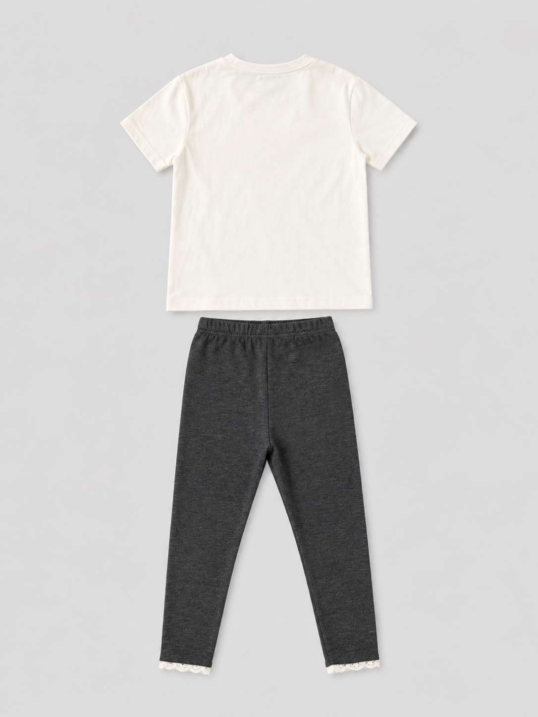 Girls ivory short-sleeve T-shirt and charcoal gray lace-trim leggings two-piece outfit, back view, size 4Y.