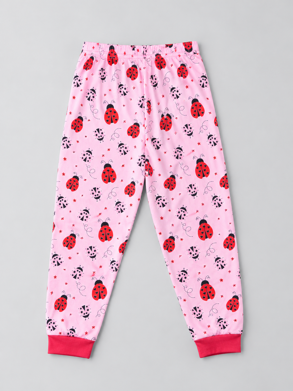Girls pink ladybug print pajama pants with elastic waist and red cuffs, back view