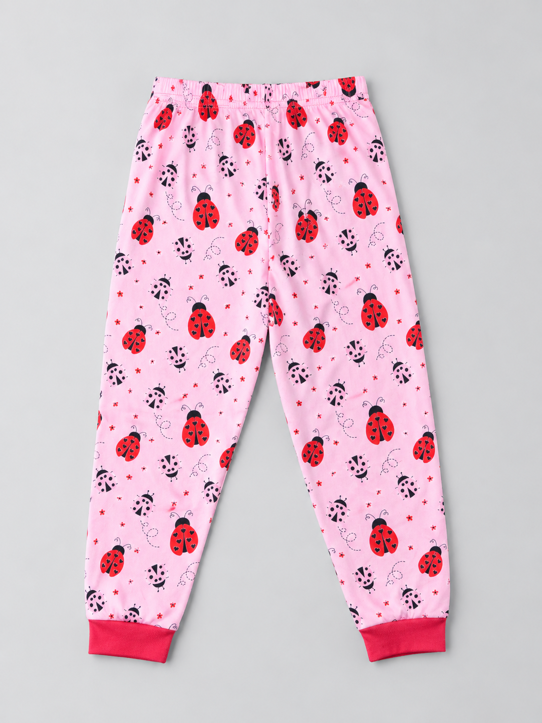 Girls pink ladybug print pajama pants with elastic waist and red cuffs, back view
