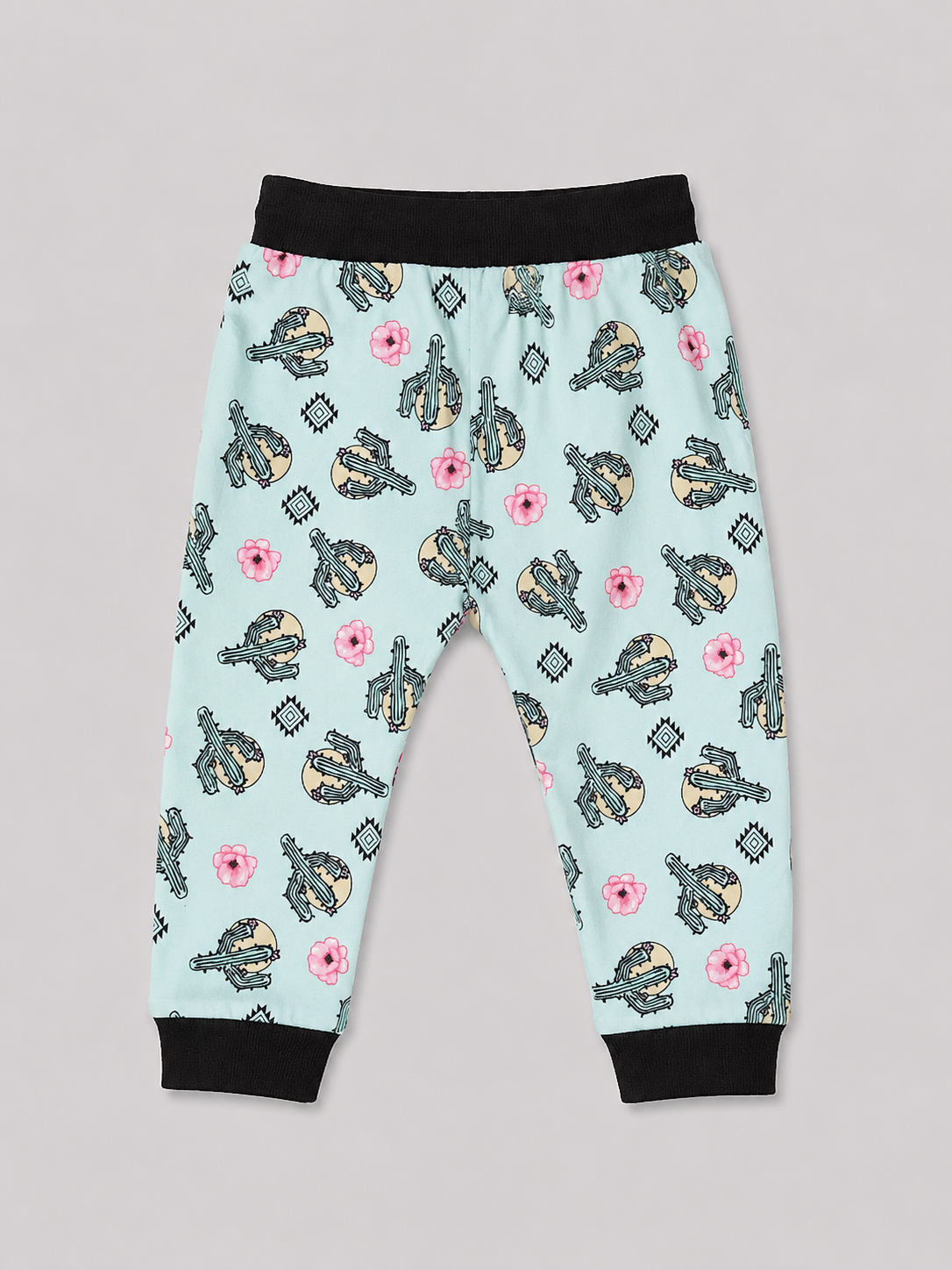 A pair of children's jogger pants with a light blue background, featuring a repeating pattern of black and yellow guitars, pink flowers, and gray diamond shapes. The pants have black elastic waistbands and black ribbed ankle cuffs.