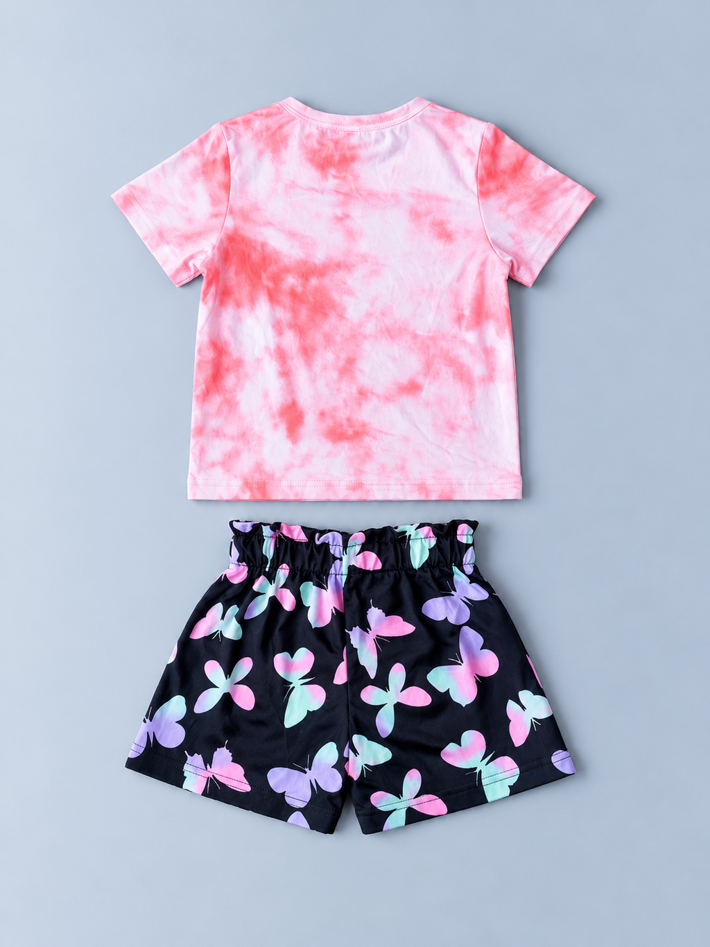 Back view of girls pink tie-dye T-shirt and black multicolor butterfly-print shorts set