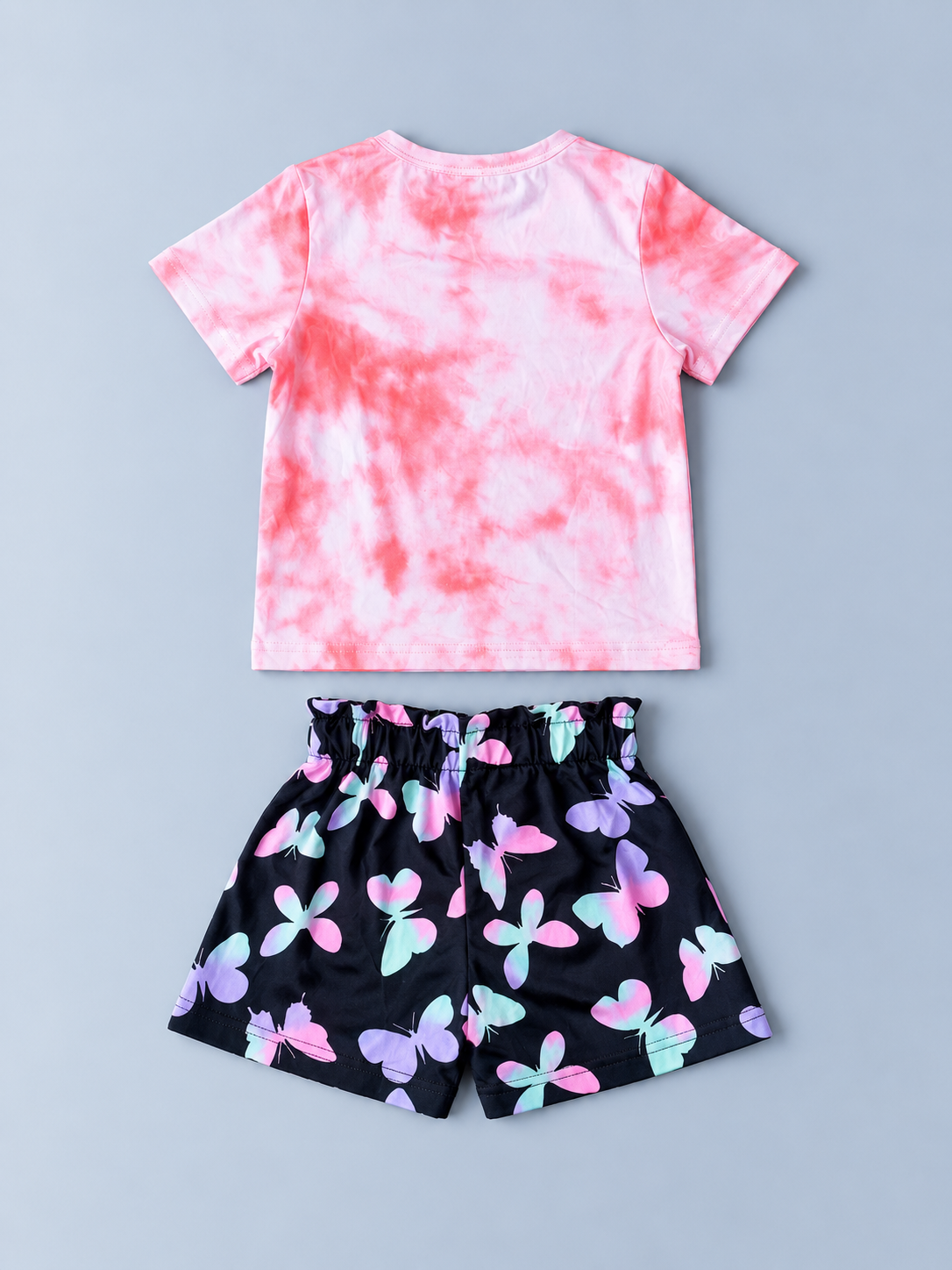 Back view of girls pink tie-dye T-shirt and black multicolor butterfly-print shorts set