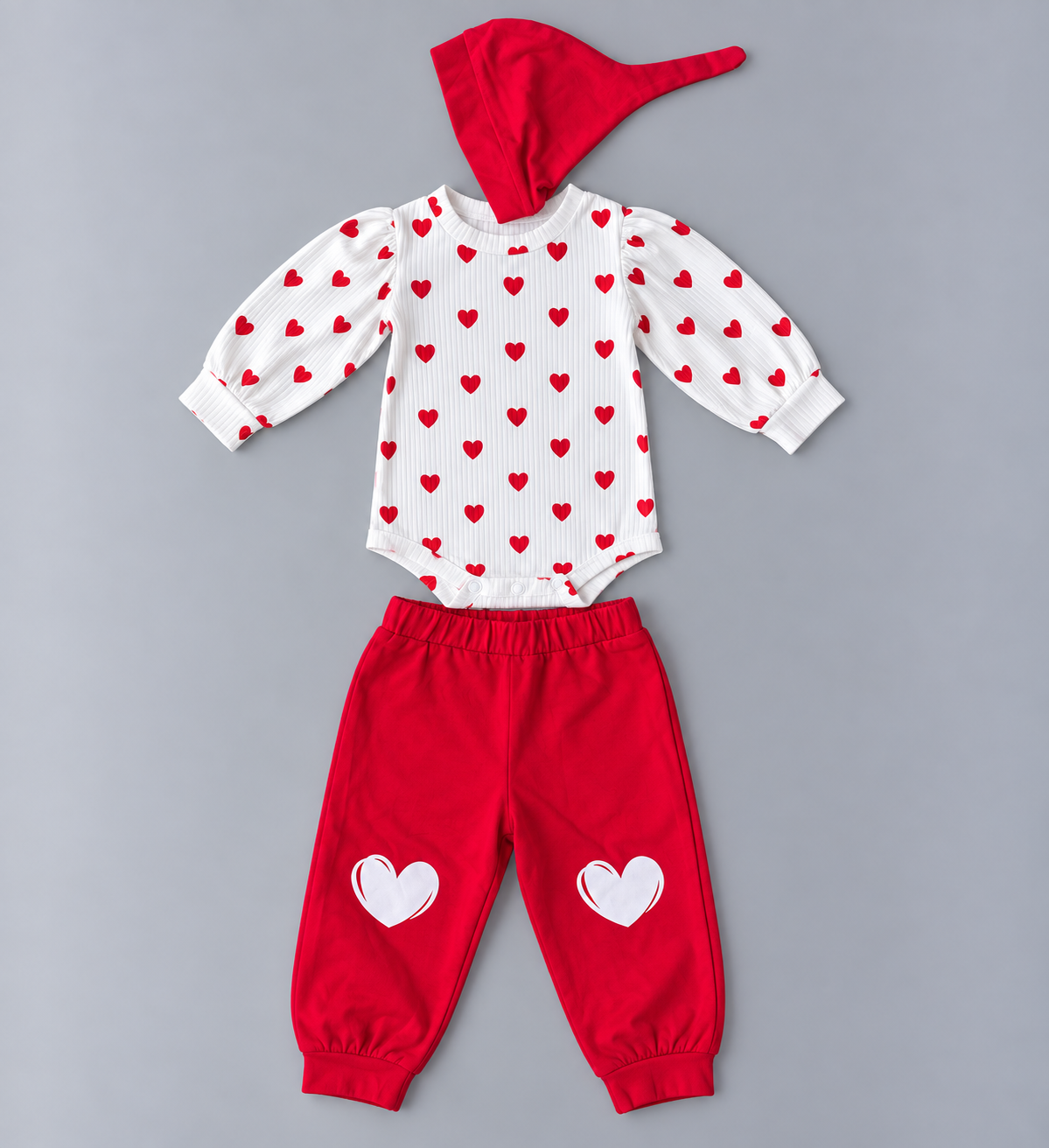 Baby three-piece red and white heart outfit with long-sleeve heart print romper, red jogger pants and matching pointed hat