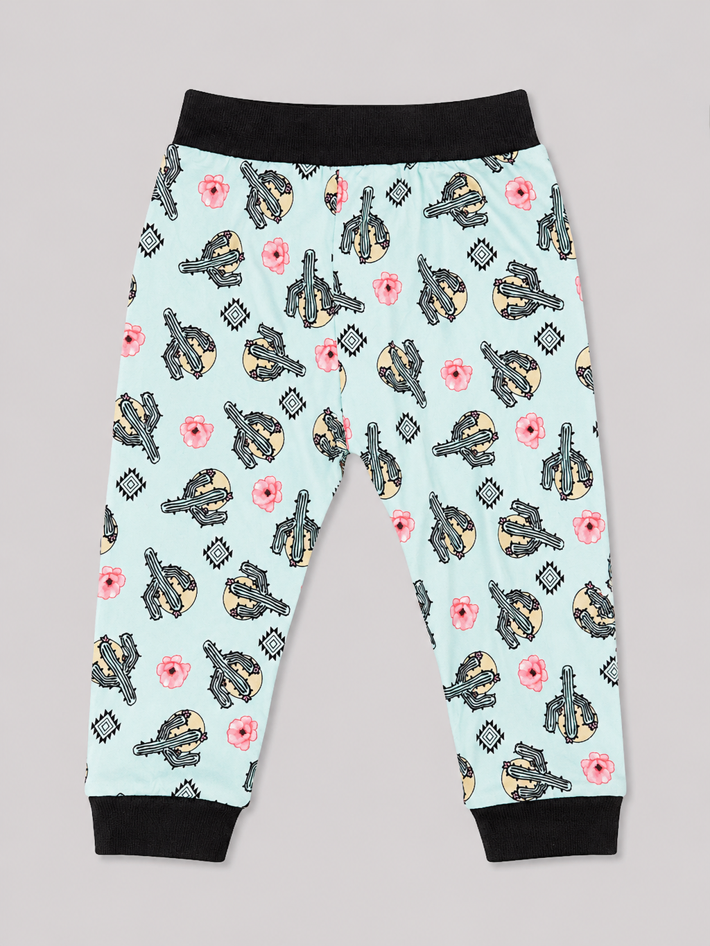A pair of children's jogger pants with a light blue background, featuring a repeating pattern of black and yellow guitars, pink flowers, and gray diamond shapes. The pants have black elastic waistbands and black ribbed ankle cuffs.