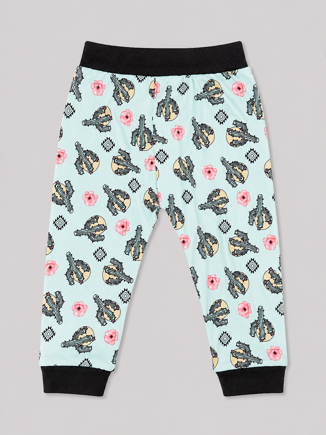 A pair of children's jogger pants with a light blue background, featuring a repeating pattern of black and yellow guitars, pink flowers, and gray diamond shapes. The pants have black elastic waistbands and black ribbed ankle cuffs.