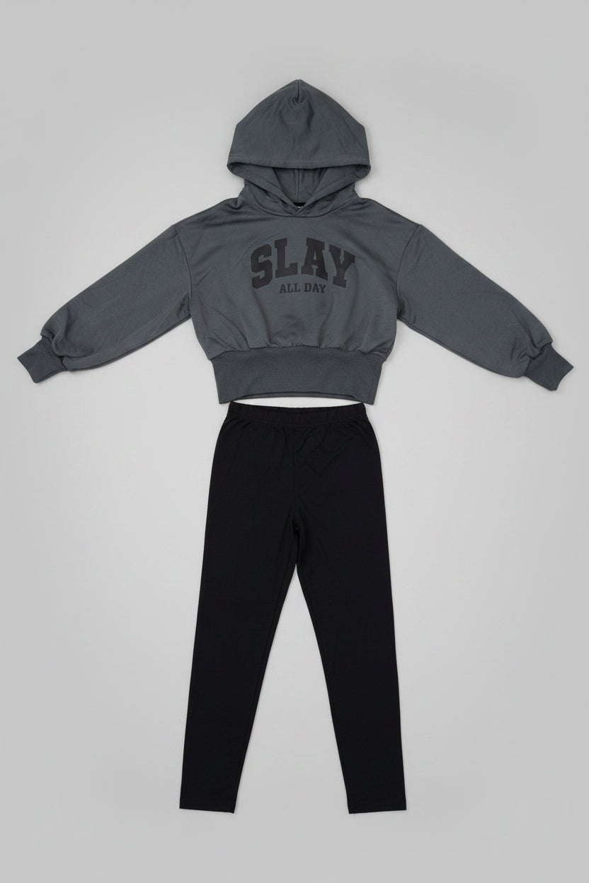 Slay All Day Hoodie & Jogger Set for girls featuring a charcoal gray cropped hooded top with bold graphic lettering and sleek black tapered pants. A trendy outfit perfect for school, casual days, lounging, and everyday wear.