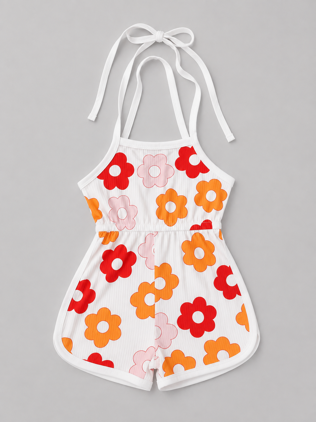 A white halter romper with a retro floral pattern in red, orange, and pink, displayed flat against a neutral gray background.