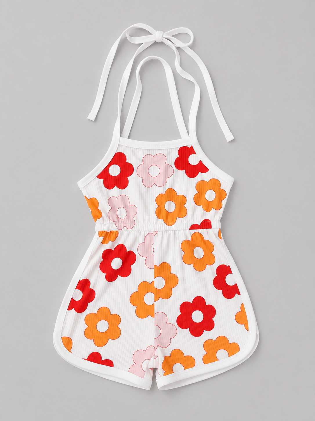 A white halter romper with a retro floral pattern in red, orange, and pink, displayed flat against a neutral gray background.