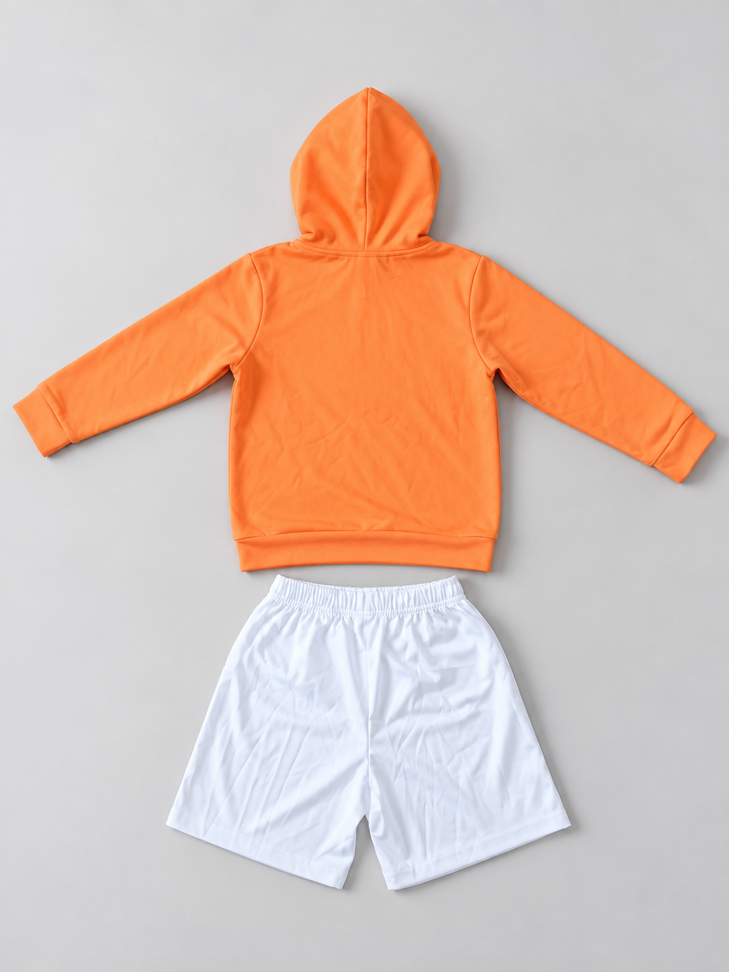 Kids orange hoodie and white elastic-waist shorts two-piece outfit, back view