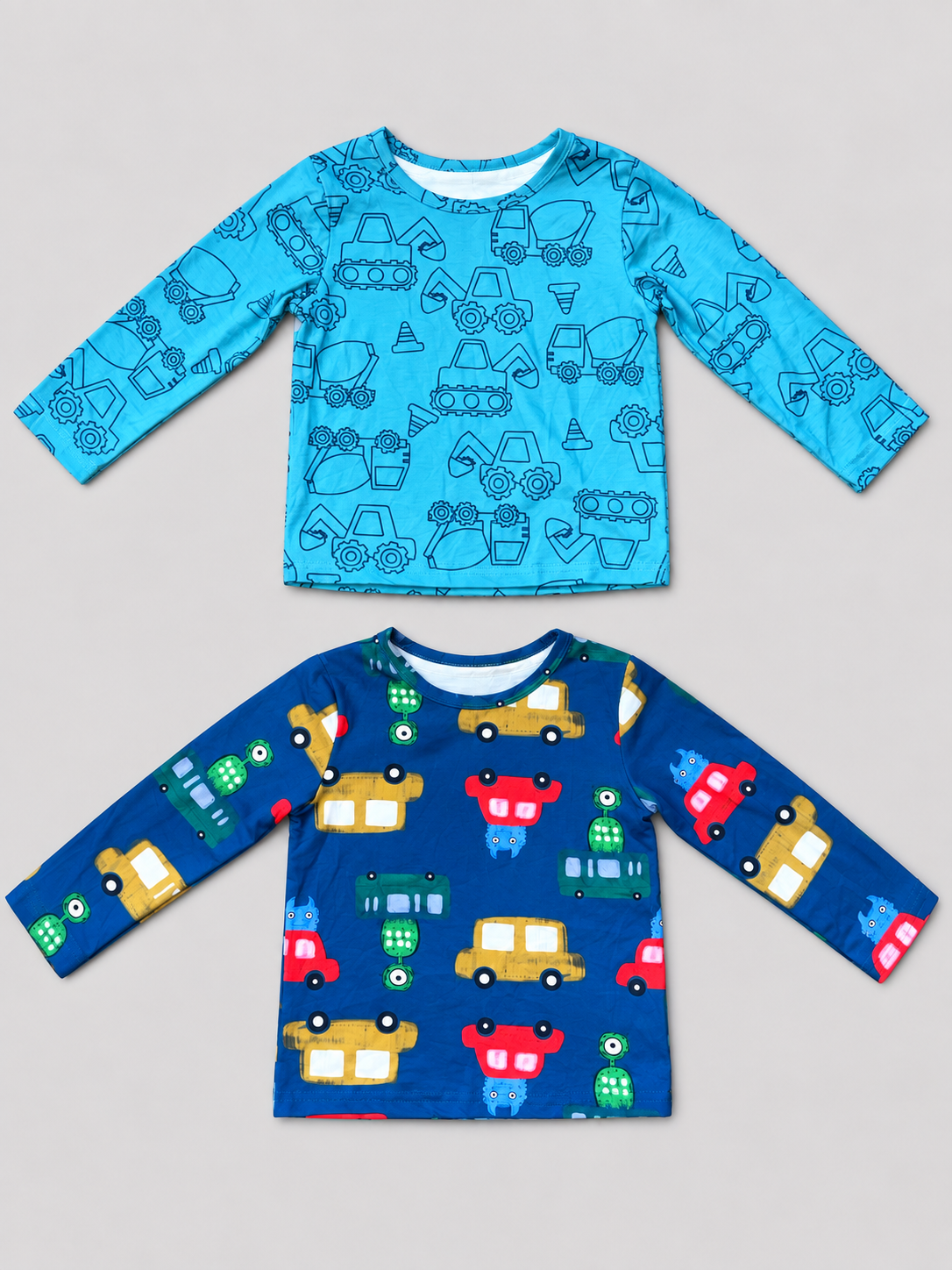 Boys 2-3Y two-pack long-sleeve shirts with turquoise construction vehicle print and deep blue colorful car print, front view.