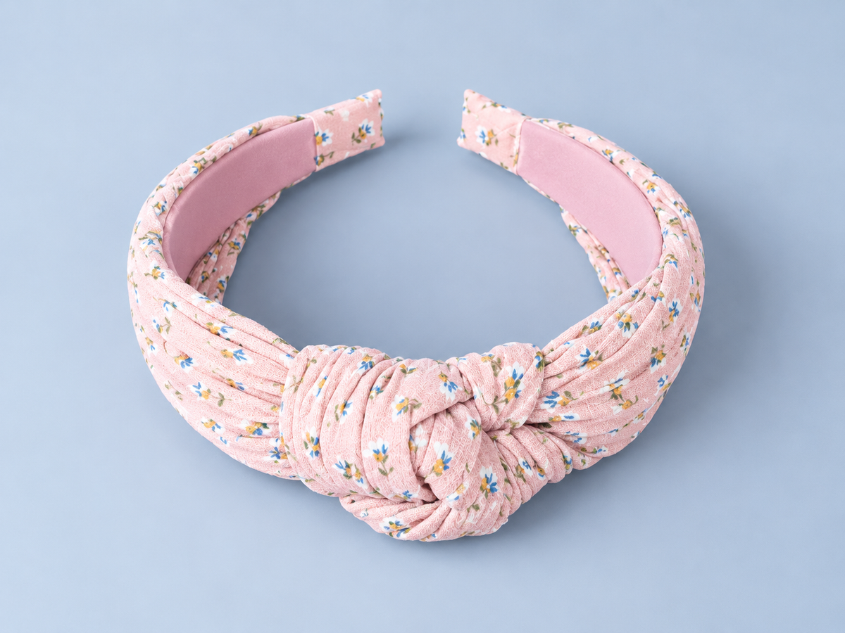 Pink floral fabric headband with knotted center detail for baby girls