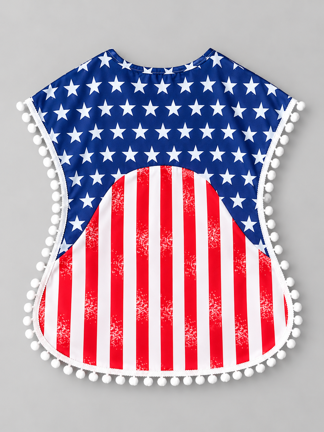 Back view of girls patriotic red white and blue dress with star print, striped skirt, and pom-pom trim