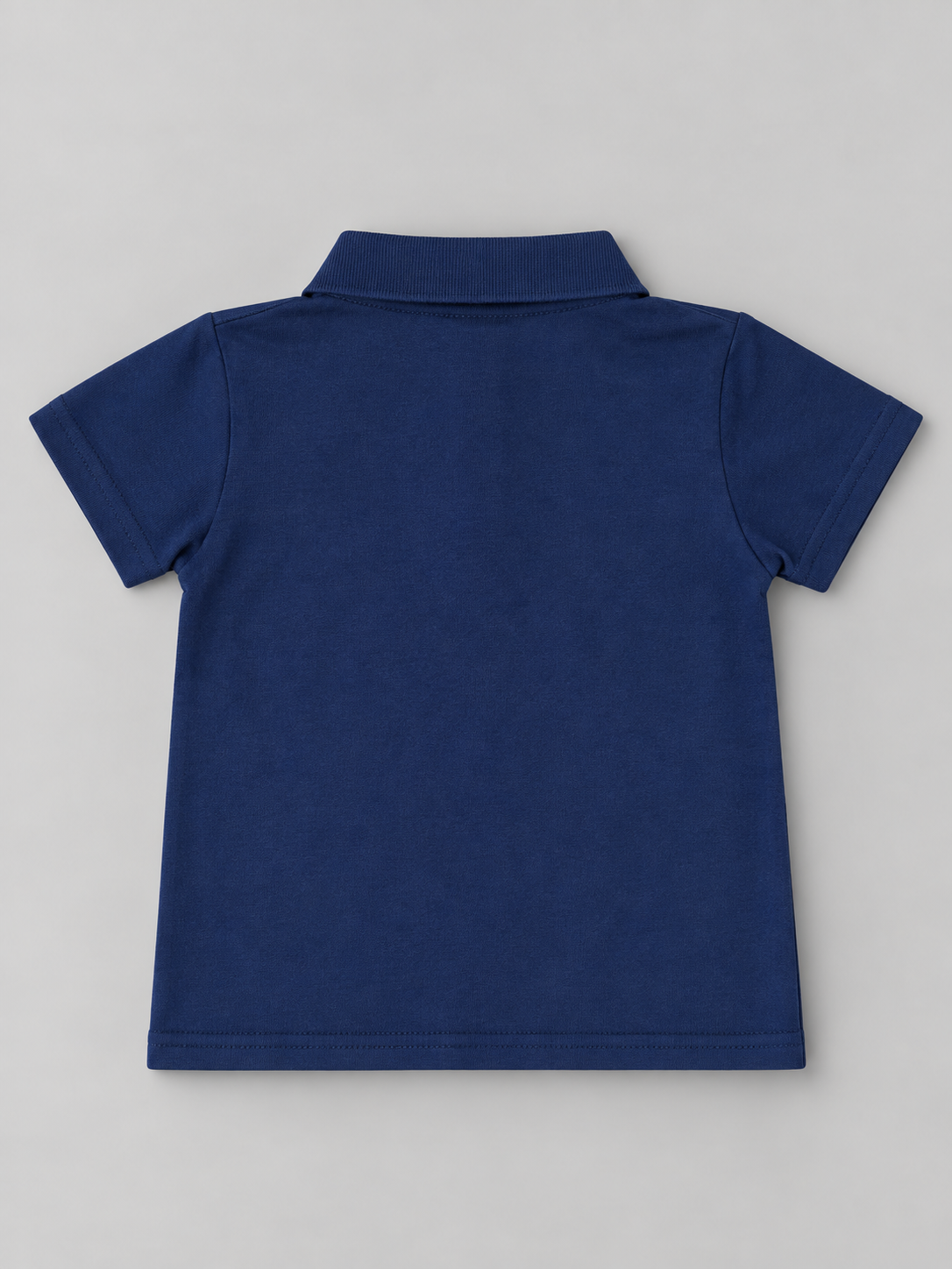 Back view of boys solid navy short sleeve polo shirt with classic collar