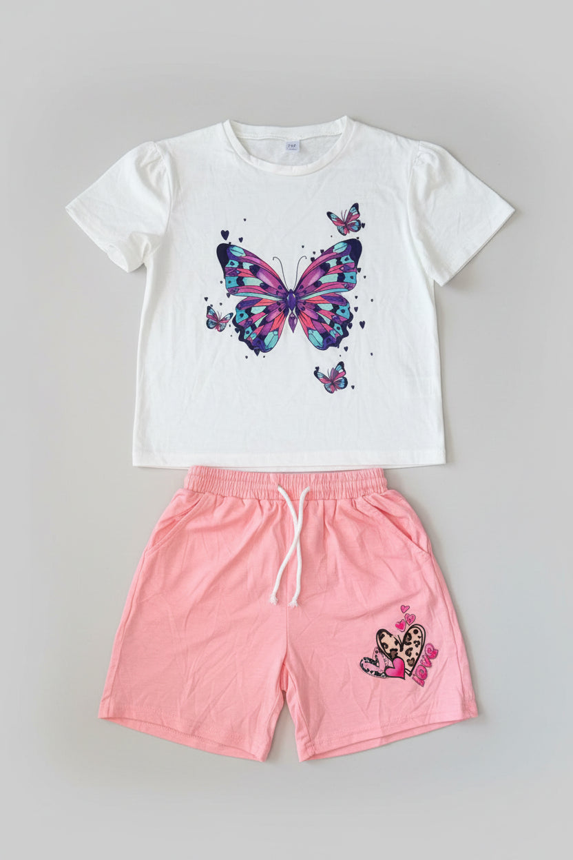 Brighten her wardrobe with this Butterfly Dreams 2-piece girls outfit featuring a colorful butterfly graphic tee and blush pink shorts. Perfect for everyday play, vacations, and summer fun.