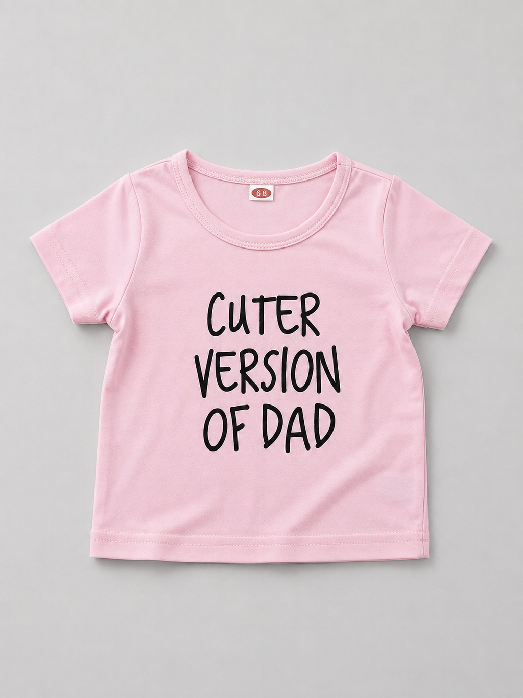 Shop this adorable pink baby girl T-shirt featuring a playful “Cuter Version of Dad” graphic. A fun and versatile short-sleeve top perfect for everyday wear, outings, and family photos.