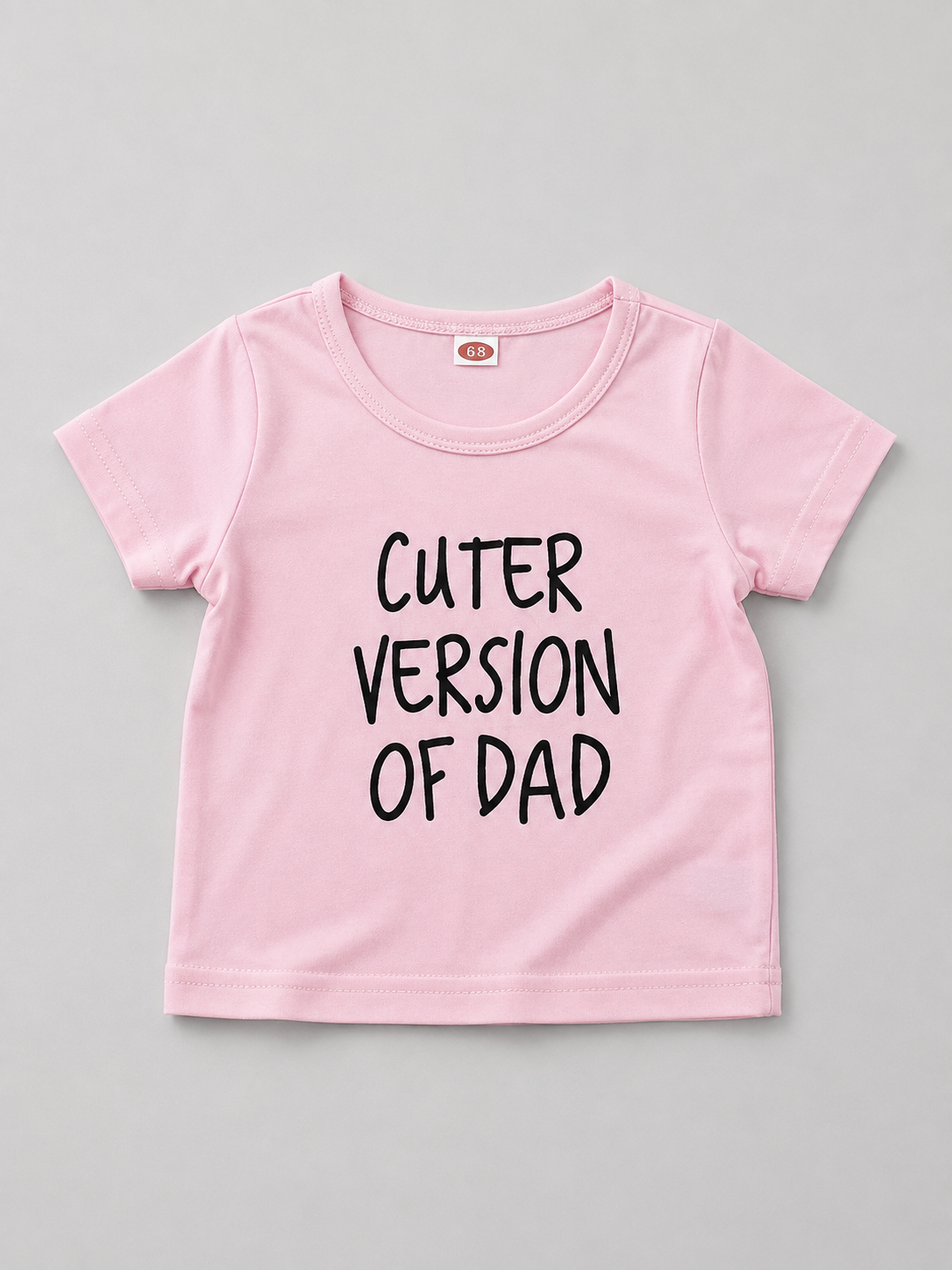 Shop this adorable pink baby girl T-shirt featuring a playful “Cuter Version of Dad” graphic. A fun and versatile short-sleeve top perfect for everyday wear, outings, and family photos.