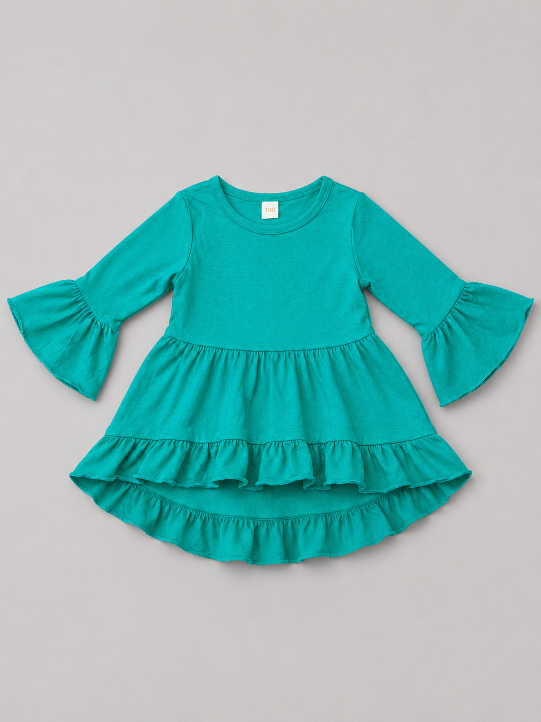 Shop this adorable turquoise girls dress featuring long bell sleeves, a tiered ruffle skirt, and a fun flowing silhouette perfect for everyday wear or special occasions.
