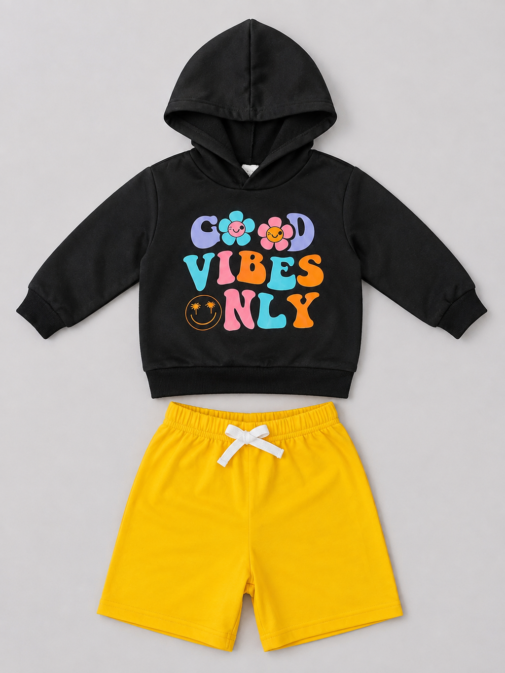 Shop the fun Good Vibes Only girls’ two-piece set featuring a colorful graphic black hoodie and bright yellow shorts. A comfortable and playful outfit for everyday wear.