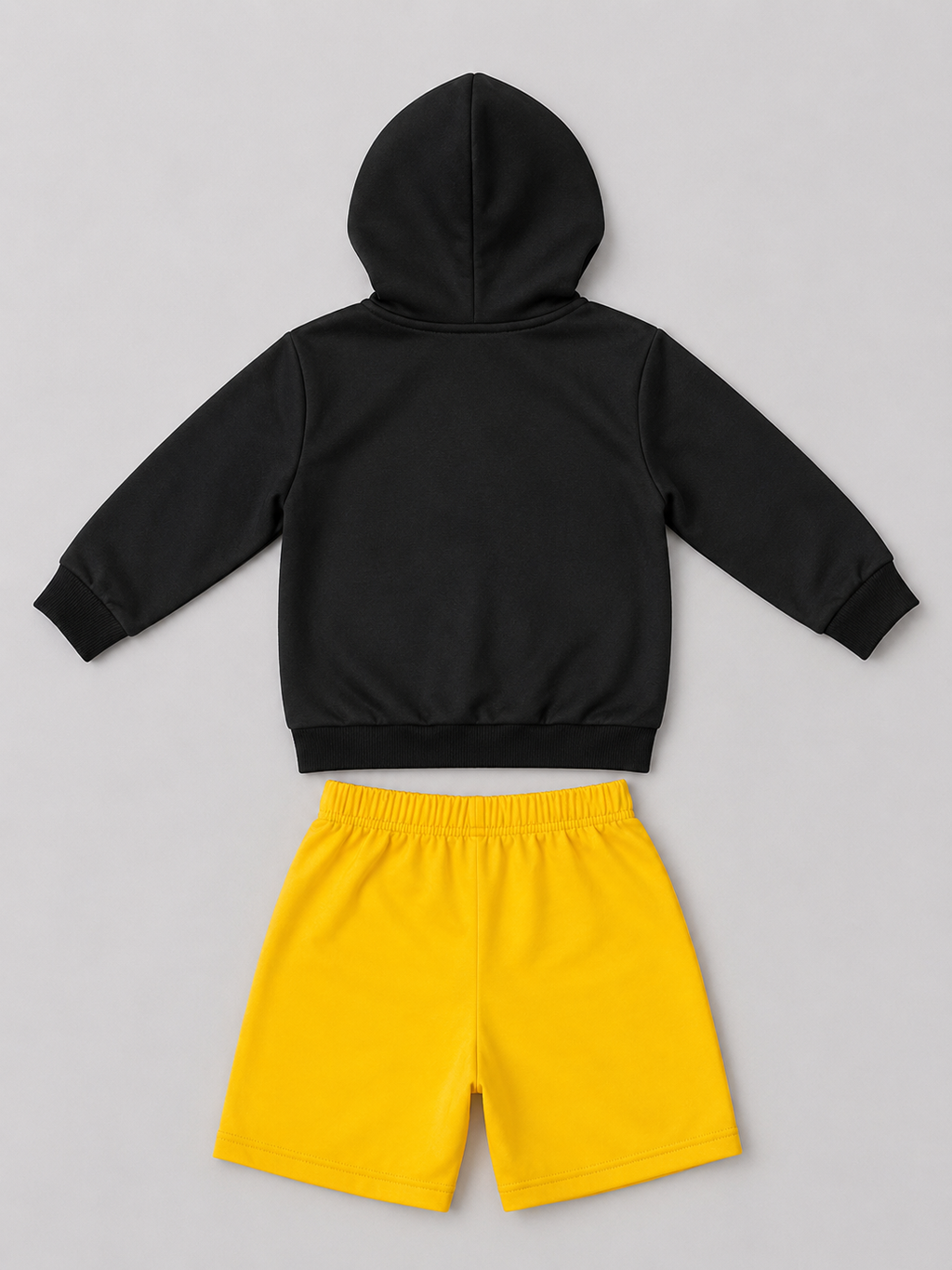 A two-piece kids' outfit set featuring a black long-sleeve hooded sweatshirt and bright yellow shorts.
