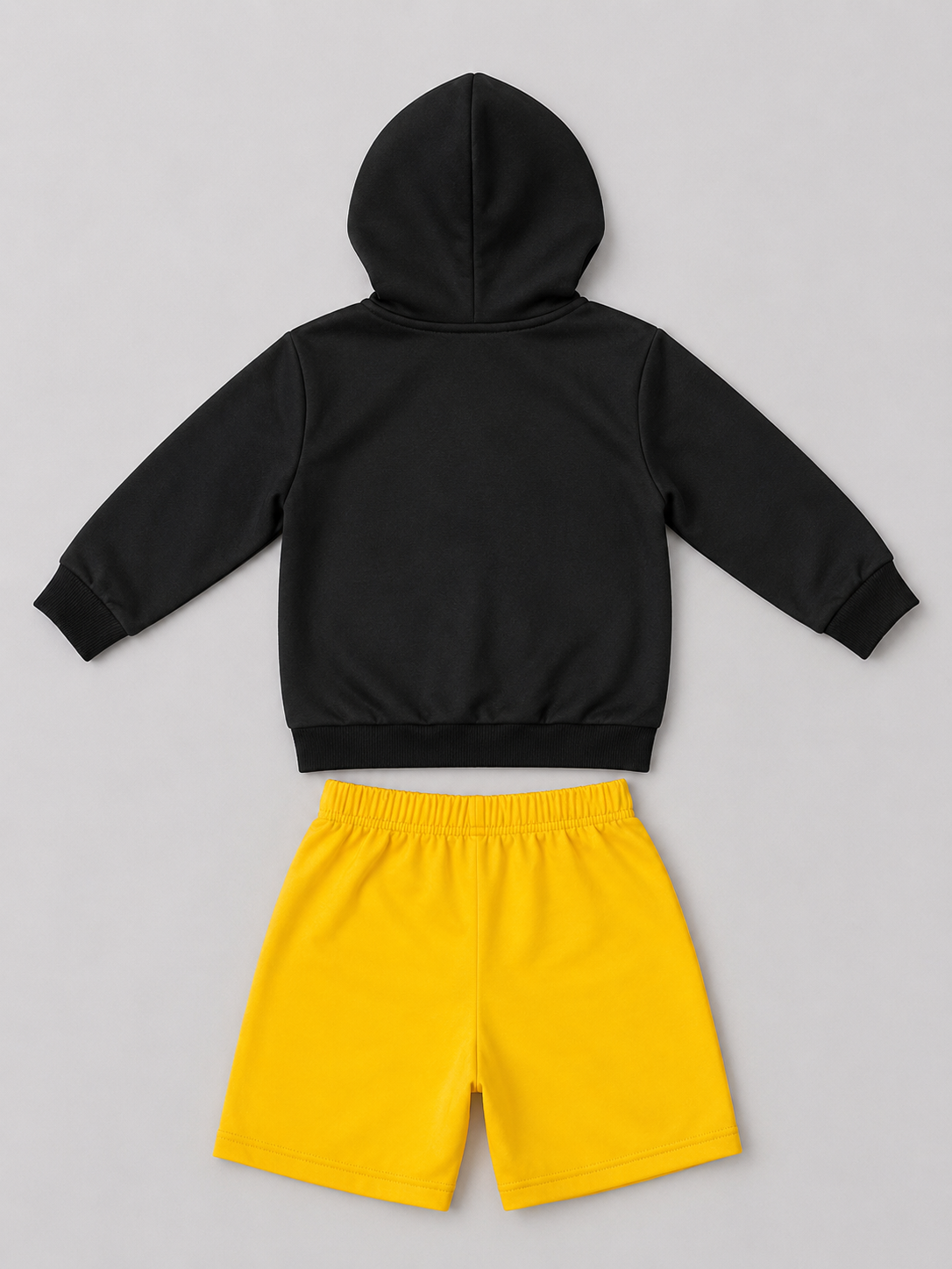 A two-piece kids' outfit set featuring a black long-sleeve hooded sweatshirt and bright yellow shorts.