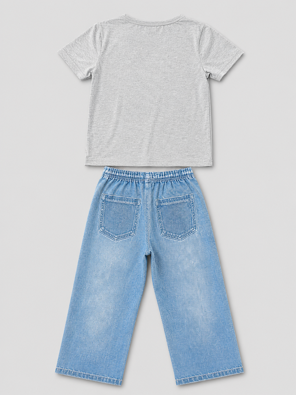 Shop this stylish girls’ two-piece outfit featuring a gray graphic T-shirt and light blue wide-leg pants with playful graffiti-inspired graphics, hearts, butterflies, and fun character details.