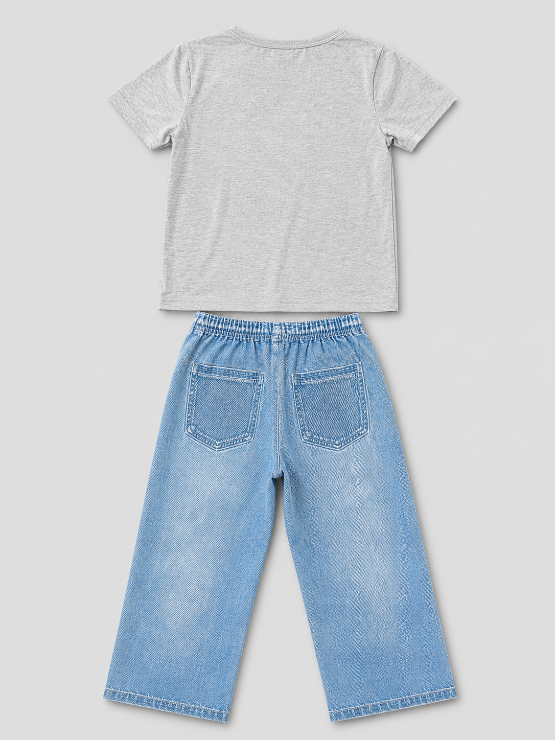 Shop this stylish girls’ two-piece outfit featuring a gray graphic T-shirt and light blue wide-leg pants with playful graffiti-inspired graphics, hearts, butterflies, and fun character details.
