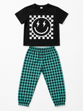 Shop this cool boys’ two-piece outfit featuring a black smiley face T-shirt with lightning bolts and teal and black checkered jogger pants. Perfect for everyday wear and casual outings.