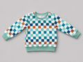 Shop this colorful kids long-sleeve sweatshirt featuring a retro checkerboard pattern in mint green, teal, navy, brown, and white with coordinating ribbed trim. Perfect for school, playtime, and everyday wear.

