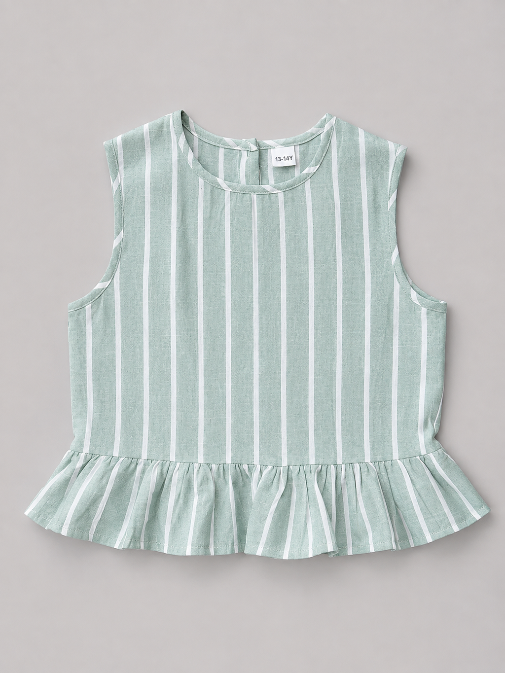 Shop this sage green and white striped girls blouse featuring a sleeveless design, gathered ruffle hem, and natural-tone back buttons. A fresh and versatile top for everyday wear, school, vacations, and special outings.