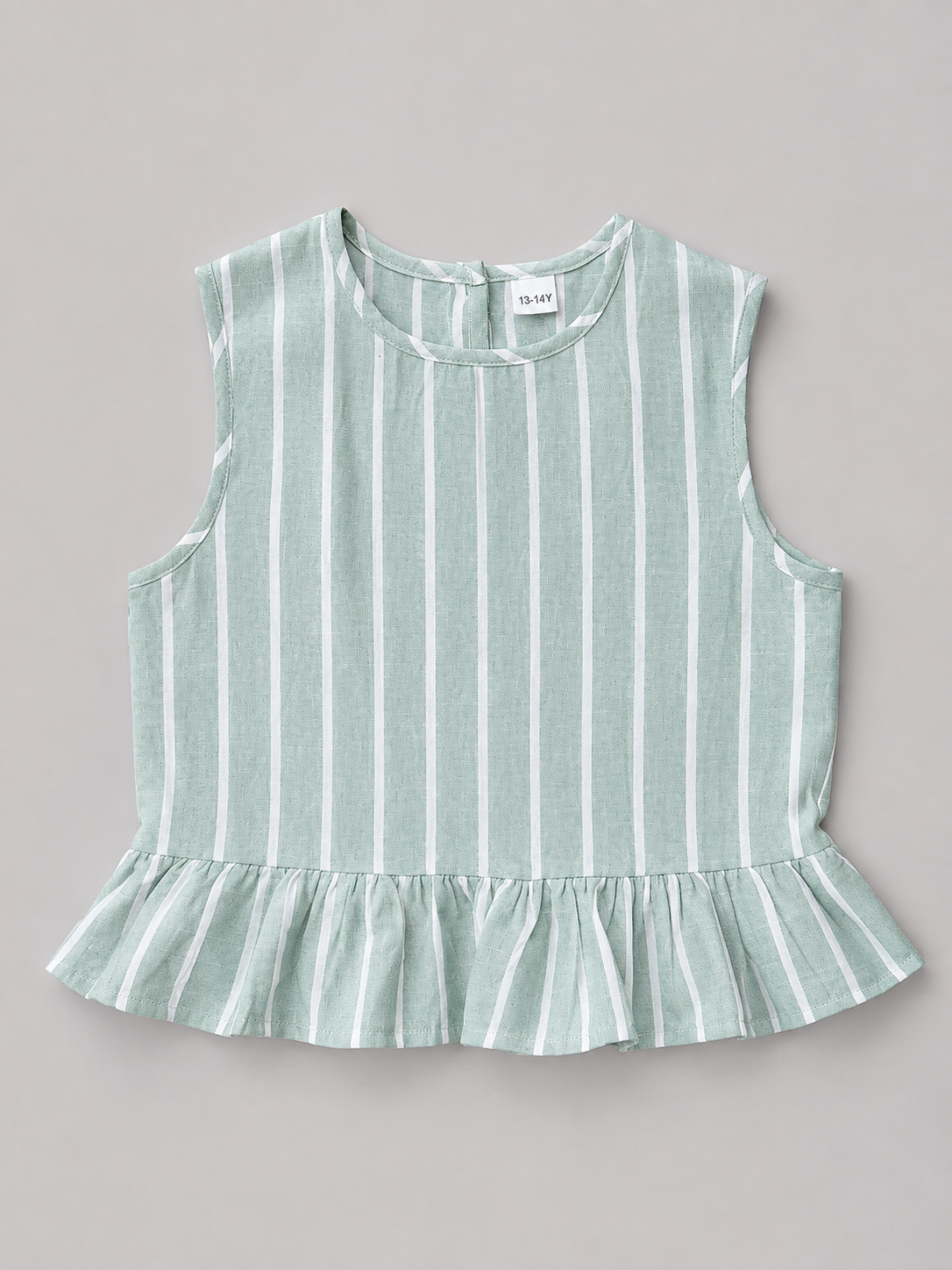 Shop this sage green and white striped girls blouse featuring a sleeveless design, gathered ruffle hem, and natural-tone back buttons. A fresh and versatile top for everyday wear, school, vacations, and special outings.