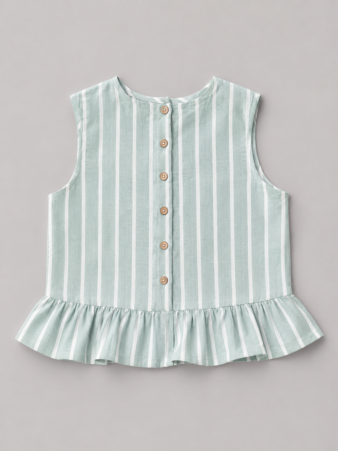 Shop this sage green and white striped girls blouse featuring a sleeveless design, gathered ruffle hem, and natural-tone back buttons. A fresh and versatile top for everyday wear, school, vacations, and special outings.